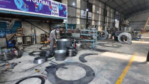 A workshop filled with machinery, materials, and a person working.